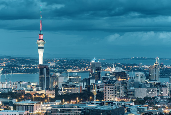 Photo of Auckland city at night, with the Sky Tower and other buildings lit up