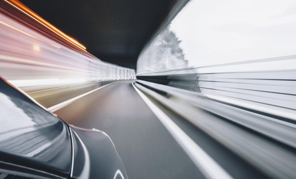 Car driving fast in tunnel