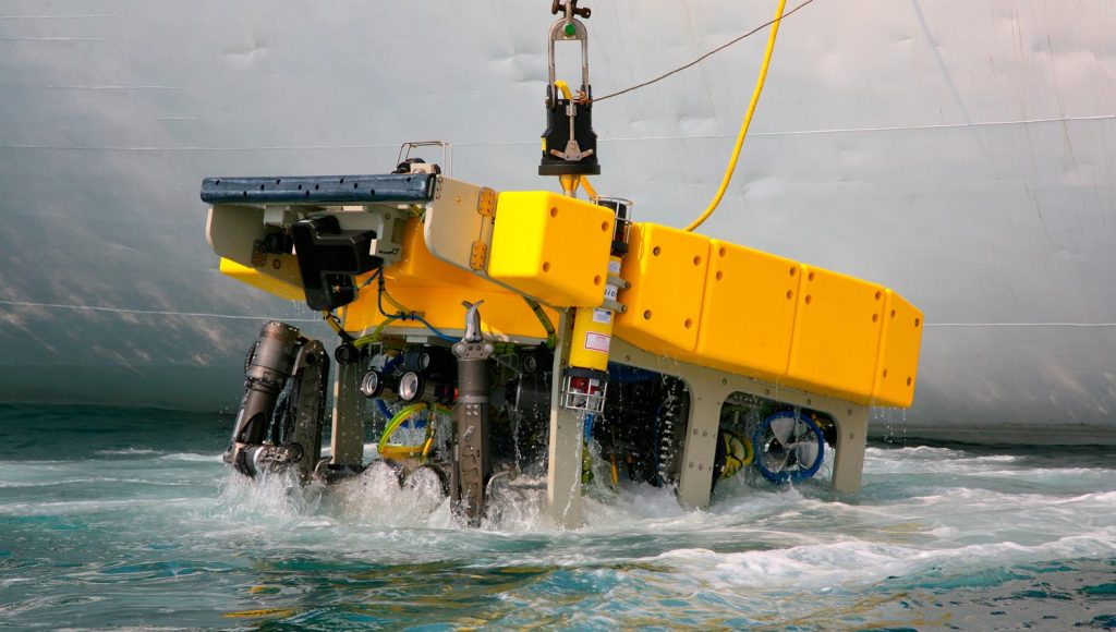 Marine robot being lowered into ocean