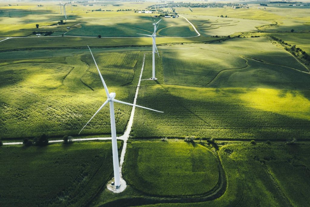 Wind turbines set amongst lush green farmland