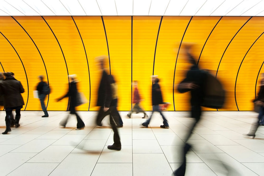 Pedestrians rushing through a tunnel